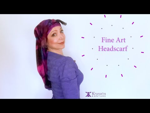 A woman in a magenta blouse shows us how to wear and tie the exquisite Krysalis Kouture Fine Art Headscarf.  It can be styled and worn in over 20 different ways