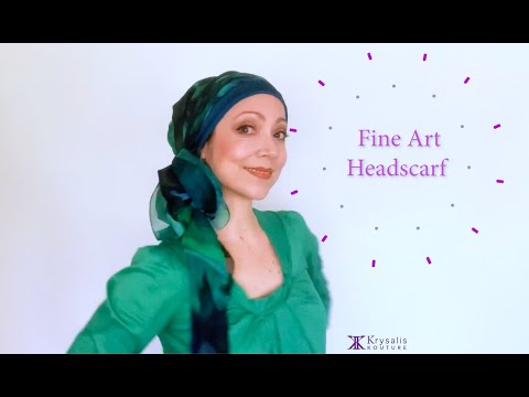 A woman in a green blouse shows us how to wear and tie the exquisite Krysalis Kouture Fine Art Headscarf.  It can be styled and worn in over 20 different ways