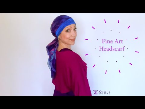 A woman in a magenta blouse shows us how to wear and tie the exquisite Krysalis Kouture Fine Art Headscarf.  It can be styled and worn in over 20 different ways